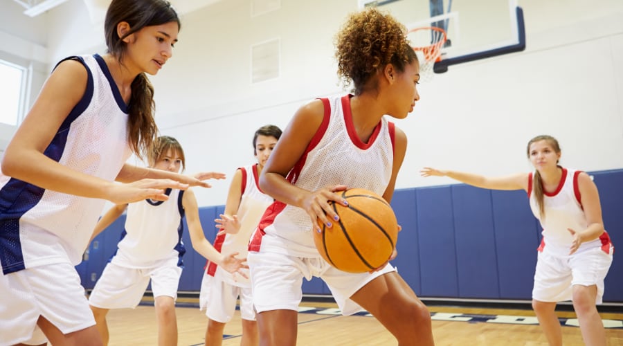 High school girls playing basketball