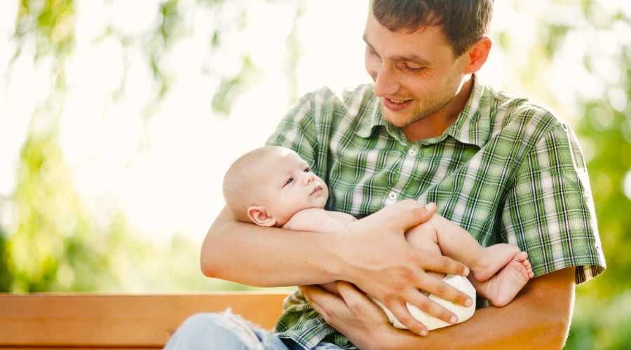 A father holds his infant