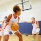 Teen girls playing basketball at school
