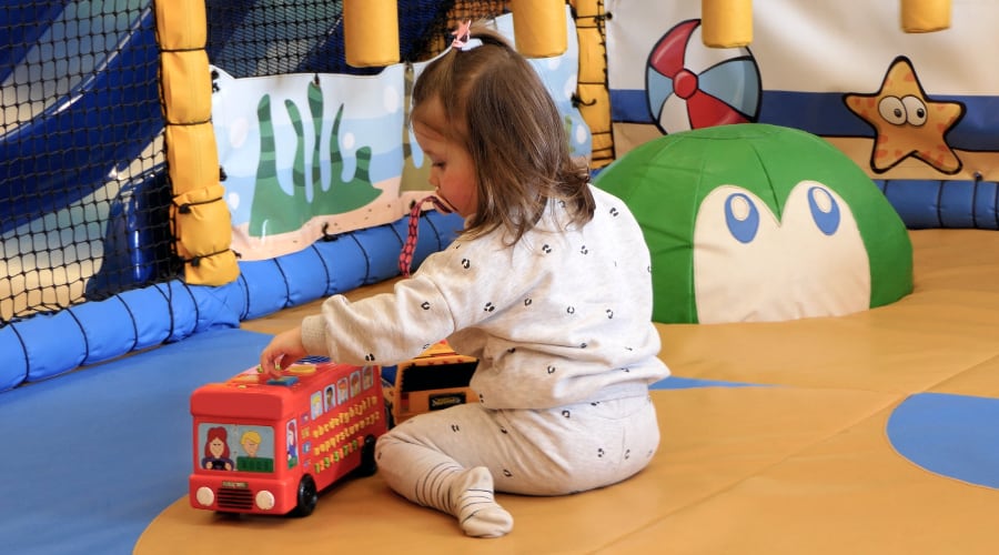 A young girl on an indoor playground