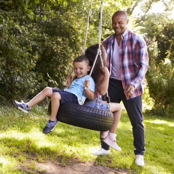 Join Our Practice Dad and his kids playing on the backyard tire swing